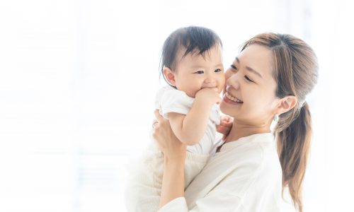 Baby and mother relaxing at home